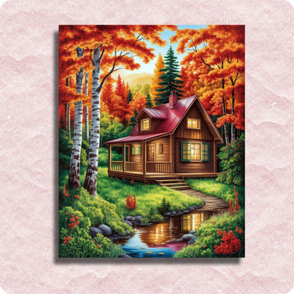 Painting of a wooden cabin in a forest with autumn foliage on a pink textured background. Autumn Forest Colors - Paint by numbers