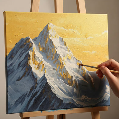 Person painting a mountain scene on a canvas with a paintbrush.