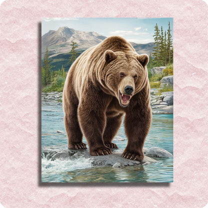 Grizzly bear standing on a rock in a mountainous landscape with a pink textured border. Guardian of the River - Paint by numbers