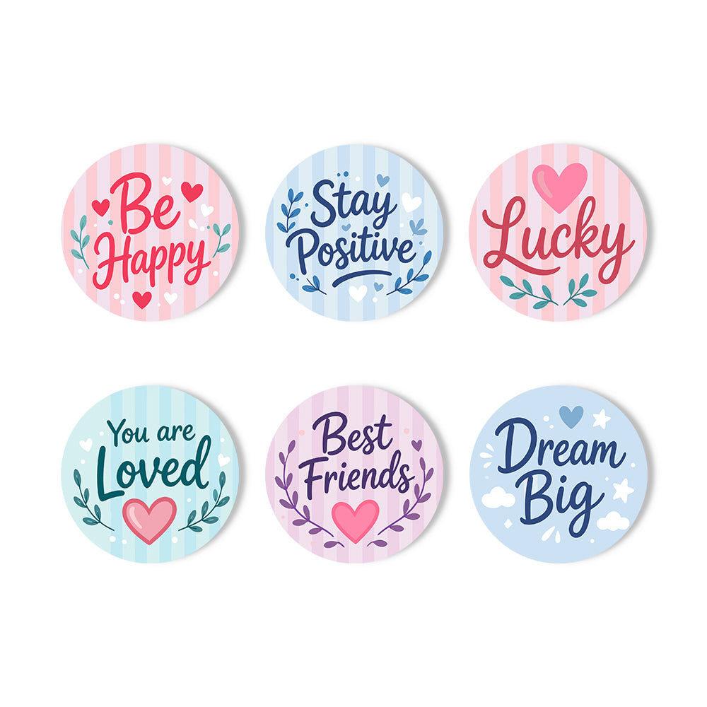Six round decorative stickers with pastel striped backgrounds and positive phrases including 'Be Happy,' 'Stay Positive,' 'Lucky,' 'You are Loved,' 'Best Friends,' and 'Dream Big,' arranged on a white background. Inspiring Words Coasters - 6 Pack Paint by Numbers