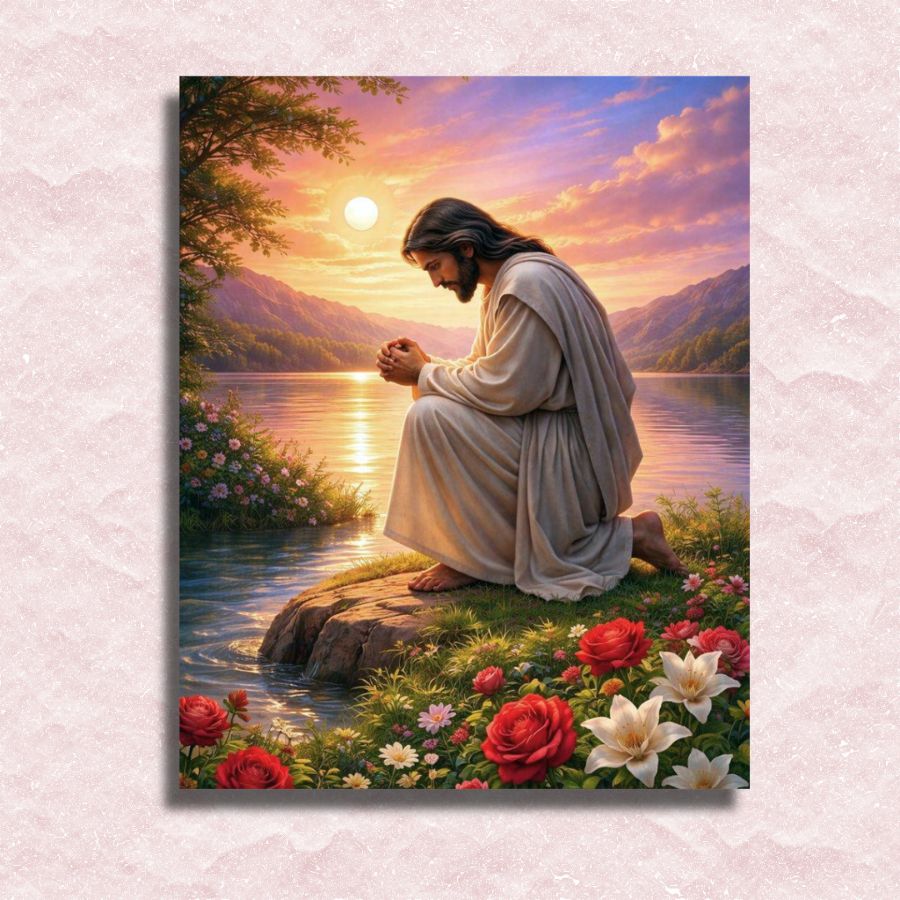 Painting of Jesus in a robe kneeling by a lake with flowers and mountains in the background. Jesus in Prayer - Paint by numbers