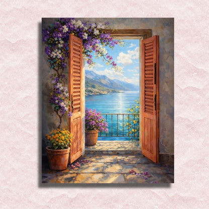 Open wooden doors leading to a scenic view of a lake with mountains and flowers. Sea View Balcony - Paint by numbers