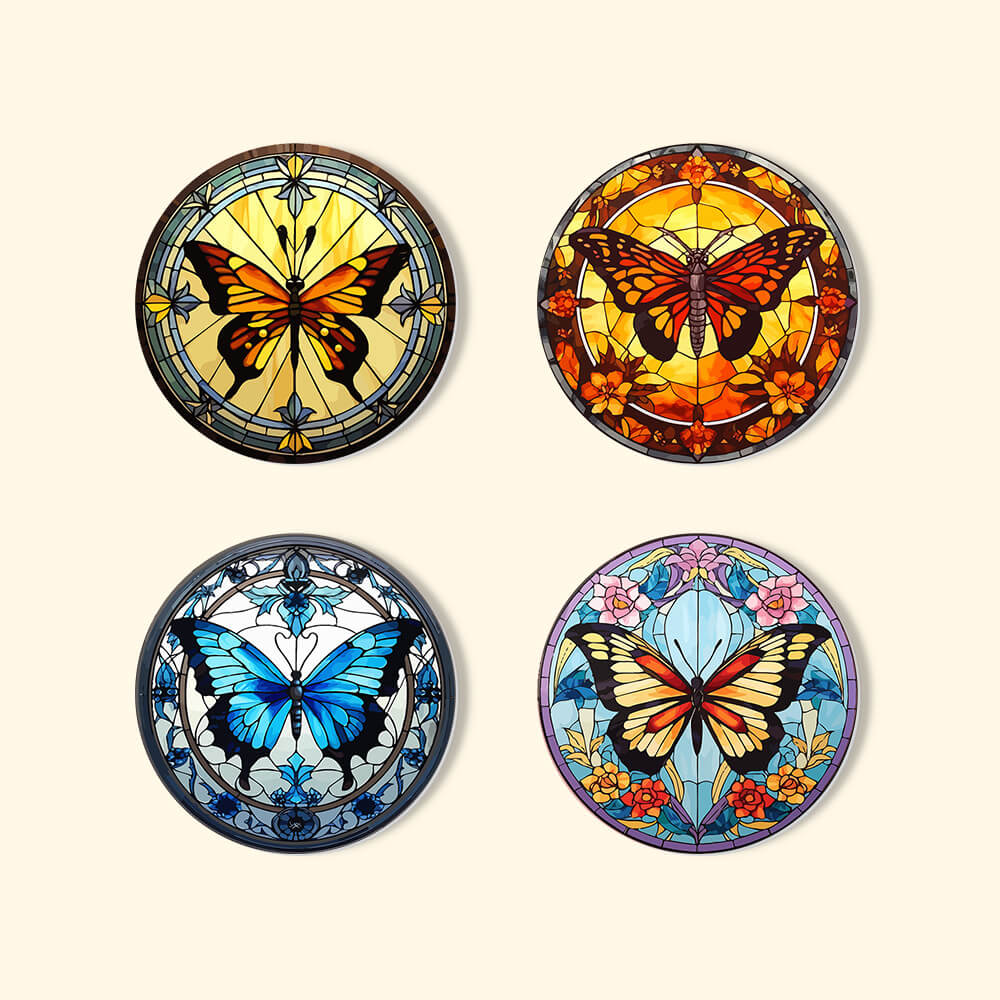 Four circular butterfly-themed coasters with stained glass designs on a light pink background. Charming Butterfly Coasters 4 Pack Paint by Numbers