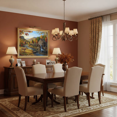 A staged dining room interior with a dark wood dining table and six upholstered chairs, set on a patterned area rug against a warm terracotta wall. A large framed landscape painting hangs above the table, with lamps, a chandelier, curtains, and a window visible. Water Mill - Paint by numbers lifestyle
